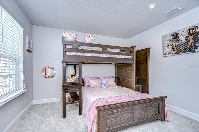 carpeted bedroom with multiple windows