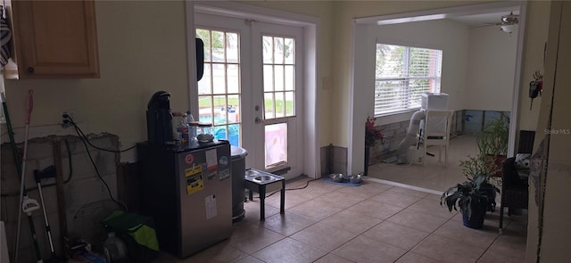 doorway featuring french doors, ceiling fan, and light tile patterned floors