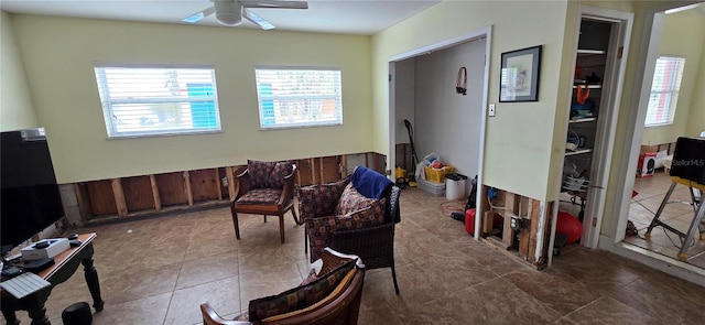 living room with a wealth of natural light and ceiling fan