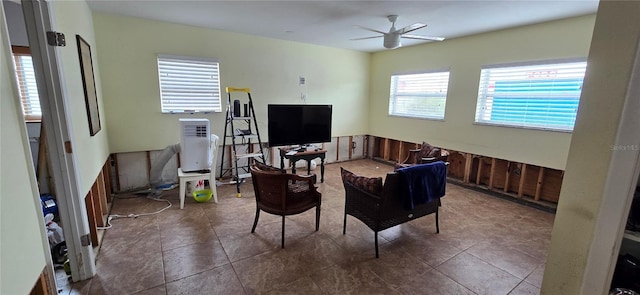 dining room featuring dark tile patterned floors, a wealth of natural light, and ceiling fan