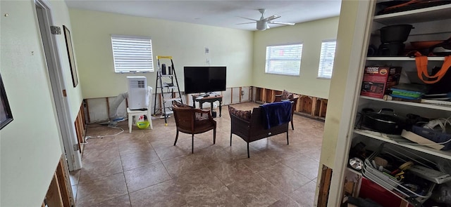 tiled living room with ceiling fan