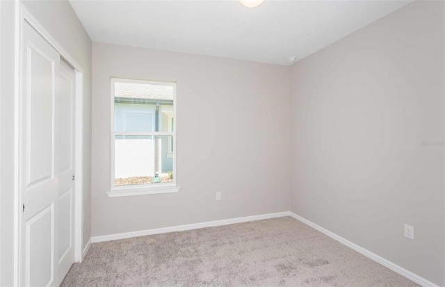 unfurnished room with light carpet