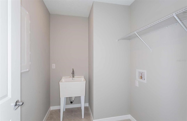 washroom with hookup for a washing machine and light tile patterned floors