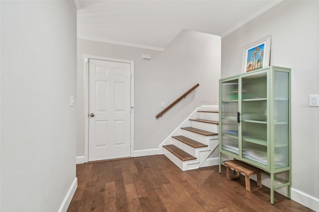 stairs with wood-type flooring and ornamental molding