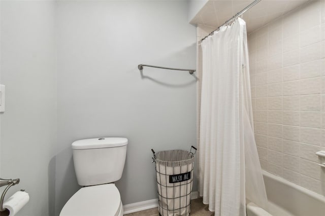 bathroom with toilet and shower / bath combo