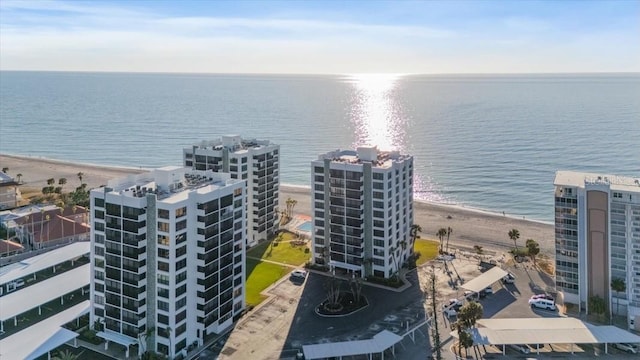 birds eye view of property featuring a beach view and a water view