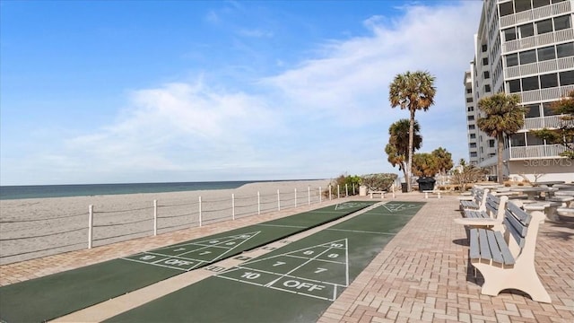 view of community with a water view and a view of the beach