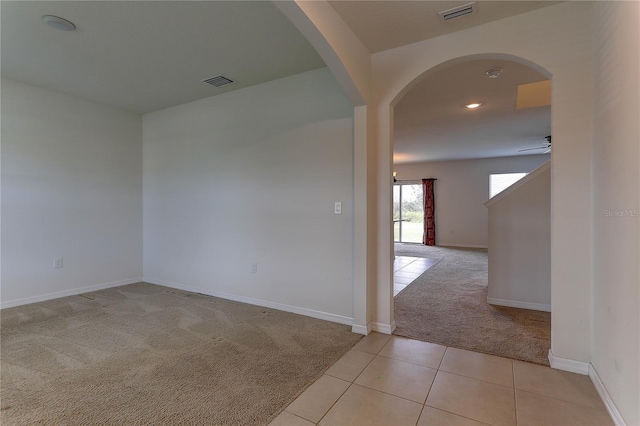 carpeted spare room featuring ceiling fan