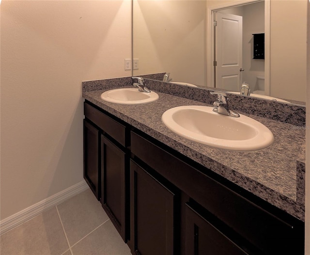 bathroom with vanity, tile patterned floors, and toilet