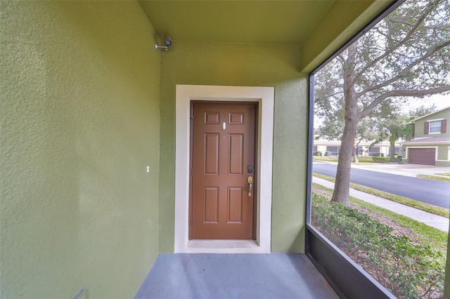 property entrance featuring stucco siding