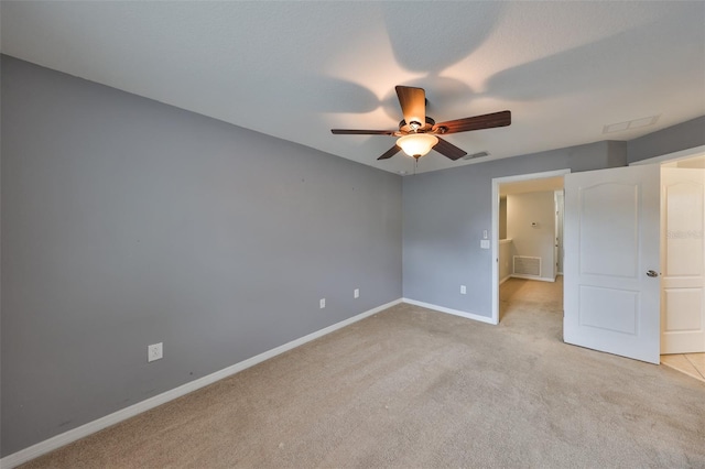 unfurnished bedroom featuring light carpet and ceiling fan