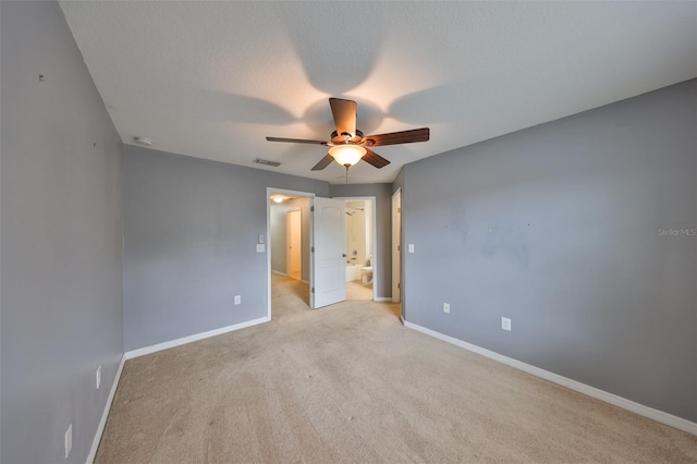 empty room with light carpet, a textured ceiling, and ceiling fan