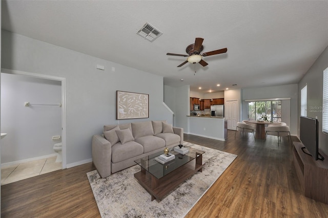 living room featuring dark wood finished floors, recessed lighting, visible vents, a ceiling fan, and baseboards