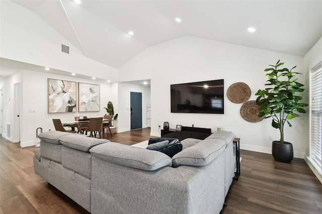 living room with vaulted ceiling and dark hardwood / wood-style floors