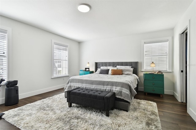 bedroom with dark hardwood / wood-style flooring