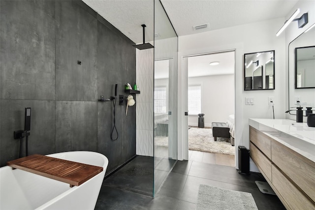 bathroom with vanity, shower with separate bathtub, and a textured ceiling