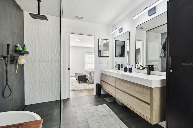 bathroom with walk in shower and vanity