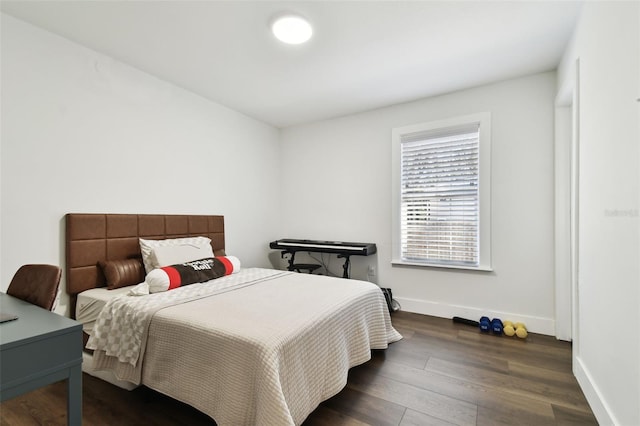 bedroom with dark hardwood / wood-style floors