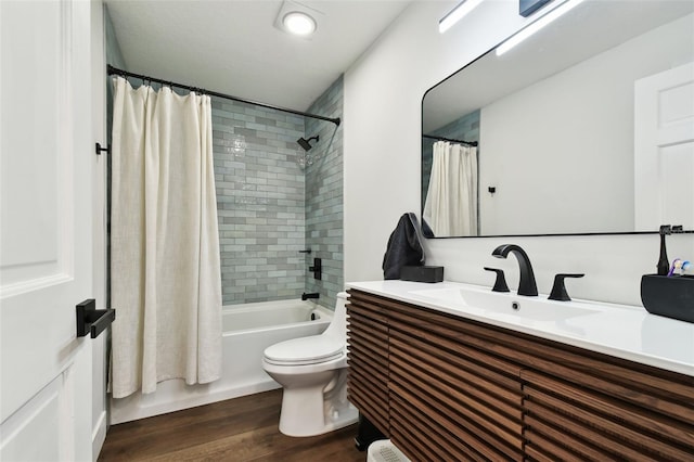 full bathroom featuring wood-type flooring, toilet, shower / bathtub combination with curtain, and vanity