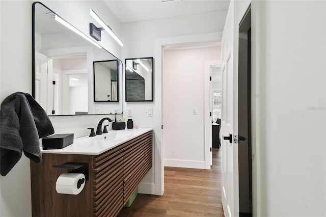 bathroom featuring wood-type flooring and vanity