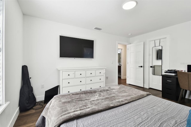 bedroom with dark hardwood / wood-style flooring