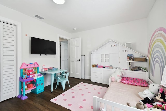 bedroom with dark hardwood / wood-style floors