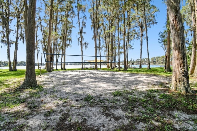 view of home's community featuring a water view and volleyball court