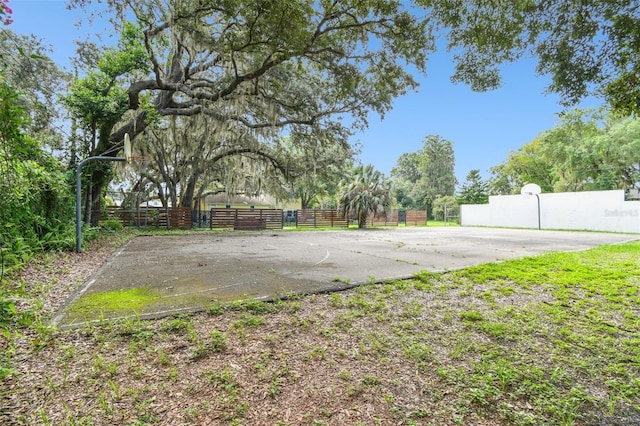 view of yard featuring basketball hoop