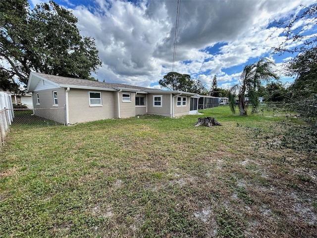 rear view of property featuring a yard