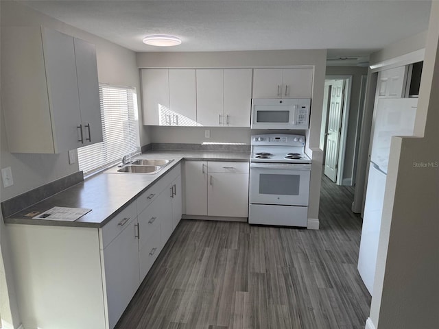 kitchen with white appliances, sink, white cabinets, and dark hardwood / wood-style floors