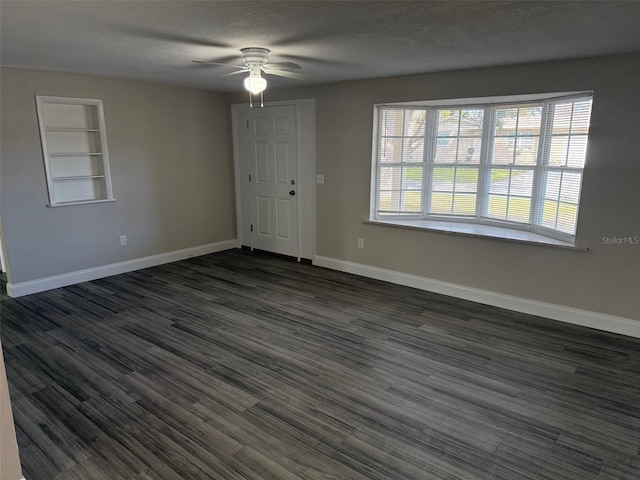 entryway featuring a textured ceiling, dark hardwood / wood-style floors, and ceiling fan