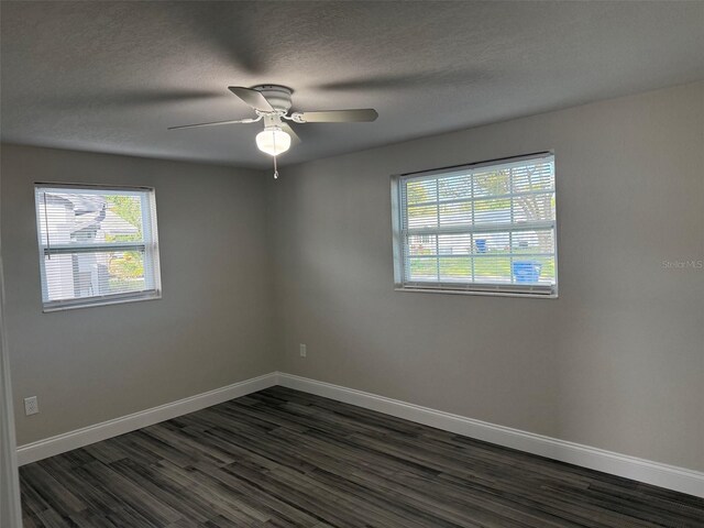 spare room with ceiling fan, dark hardwood / wood-style floors, and a textured ceiling