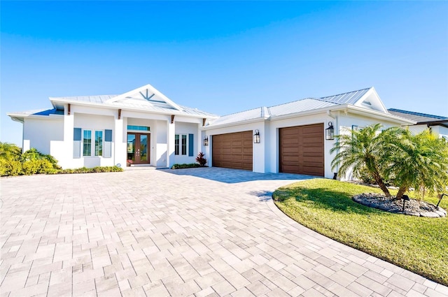 view of front facade featuring french doors, a garage, and a front yard