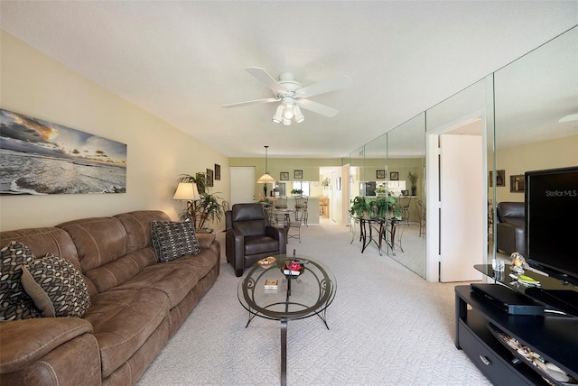 carpeted living room featuring ceiling fan