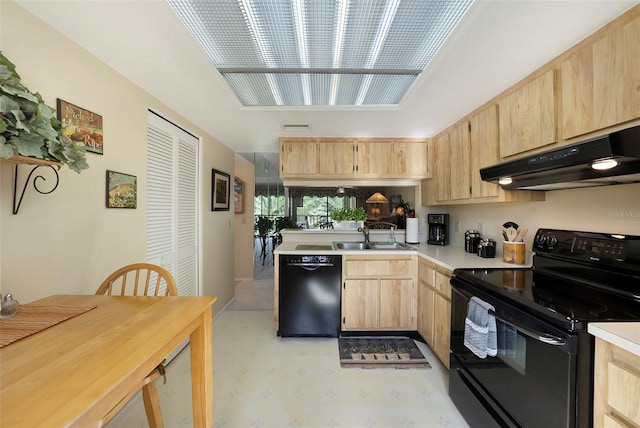 kitchen with light brown cabinetry, sink, and black appliances