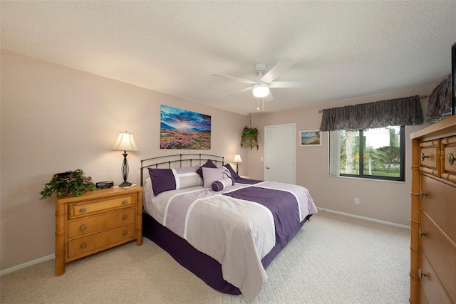 carpeted bedroom with a textured ceiling and ceiling fan