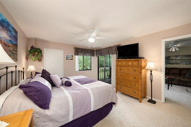 carpeted bedroom with ceiling fan, access to exterior, and a textured ceiling