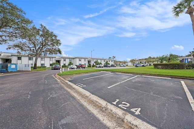 view of vehicle parking with a lawn