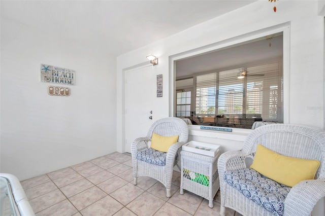 interior space featuring light tile patterned flooring and ceiling fan