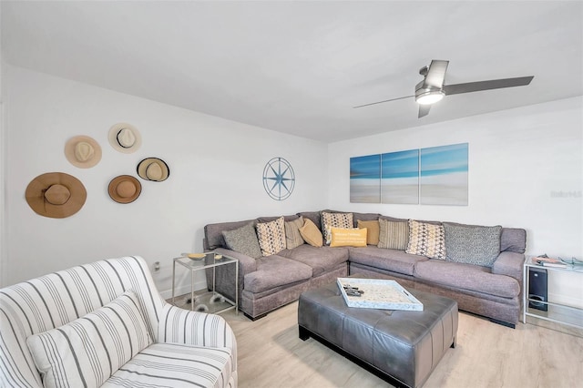 living room with ceiling fan and light wood-type flooring