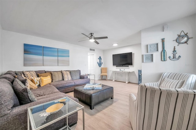 living room with ceiling fan and light wood-type flooring