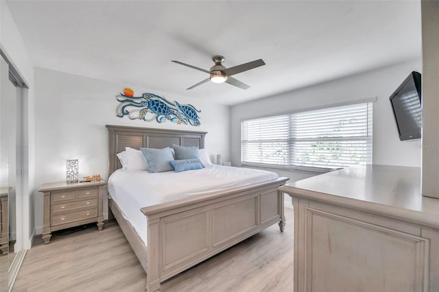 bedroom featuring light wood-type flooring, ceiling fan, and a closet