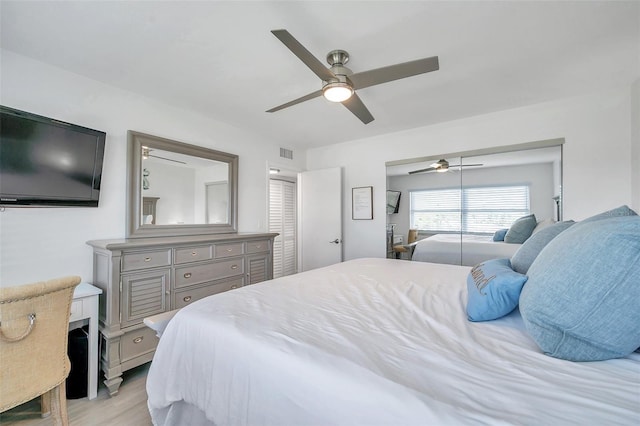 bedroom with ceiling fan, a closet, and light wood-type flooring