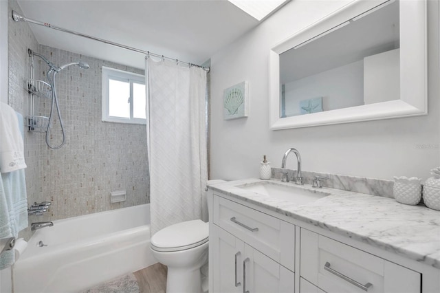 full bathroom with hardwood / wood-style flooring, vanity, shower / bath combo with shower curtain, and toilet