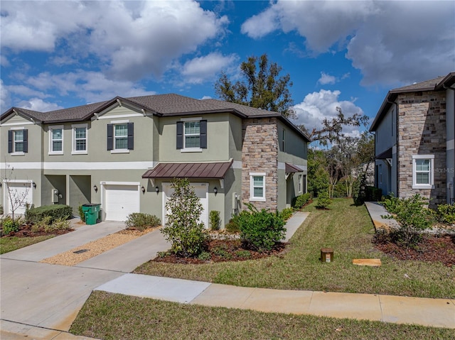 townhome / multi-family property with a garage and a front lawn