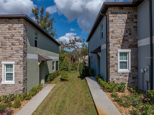 view of side of home with a lawn