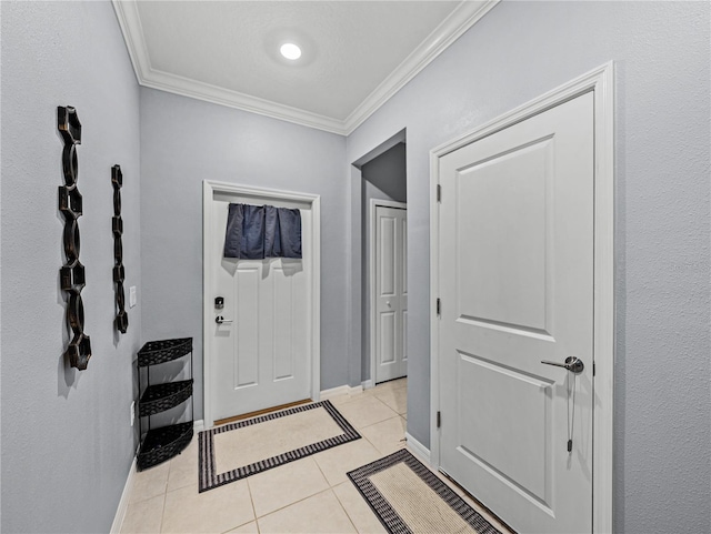 entrance foyer with light tile patterned floors and crown molding