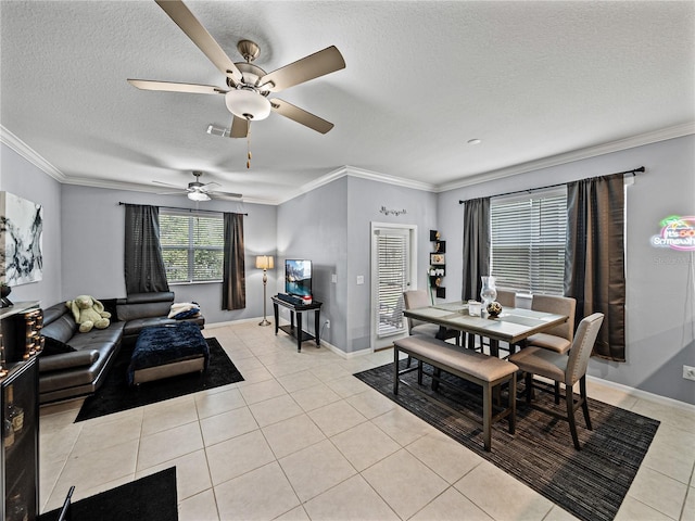 tiled dining space featuring crown molding and a textured ceiling