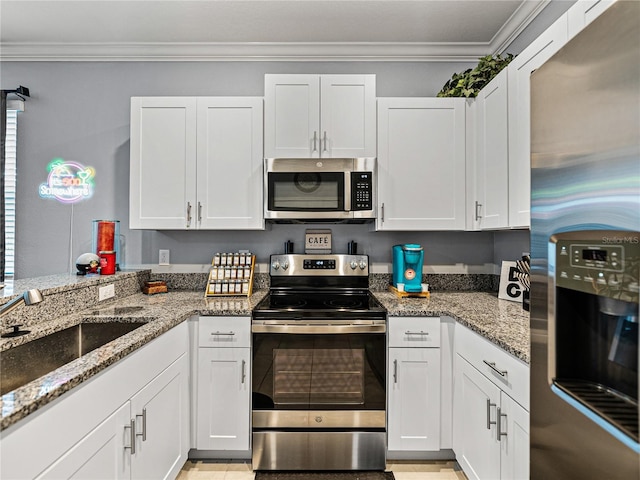 kitchen with stone counters, white cabinets, and appliances with stainless steel finishes