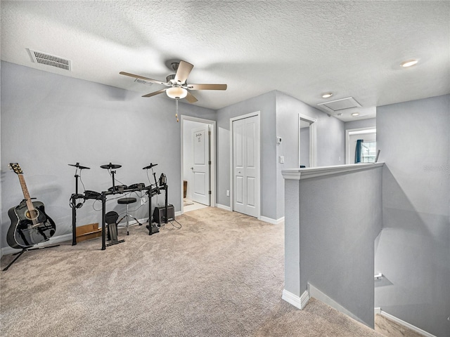 interior space featuring light colored carpet and a textured ceiling